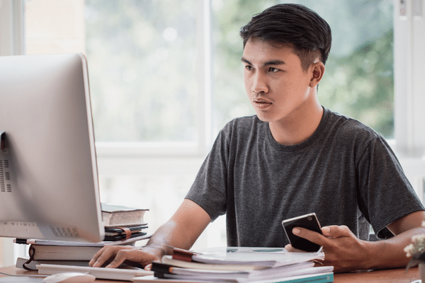 student on computer, business studies assessment and reporting